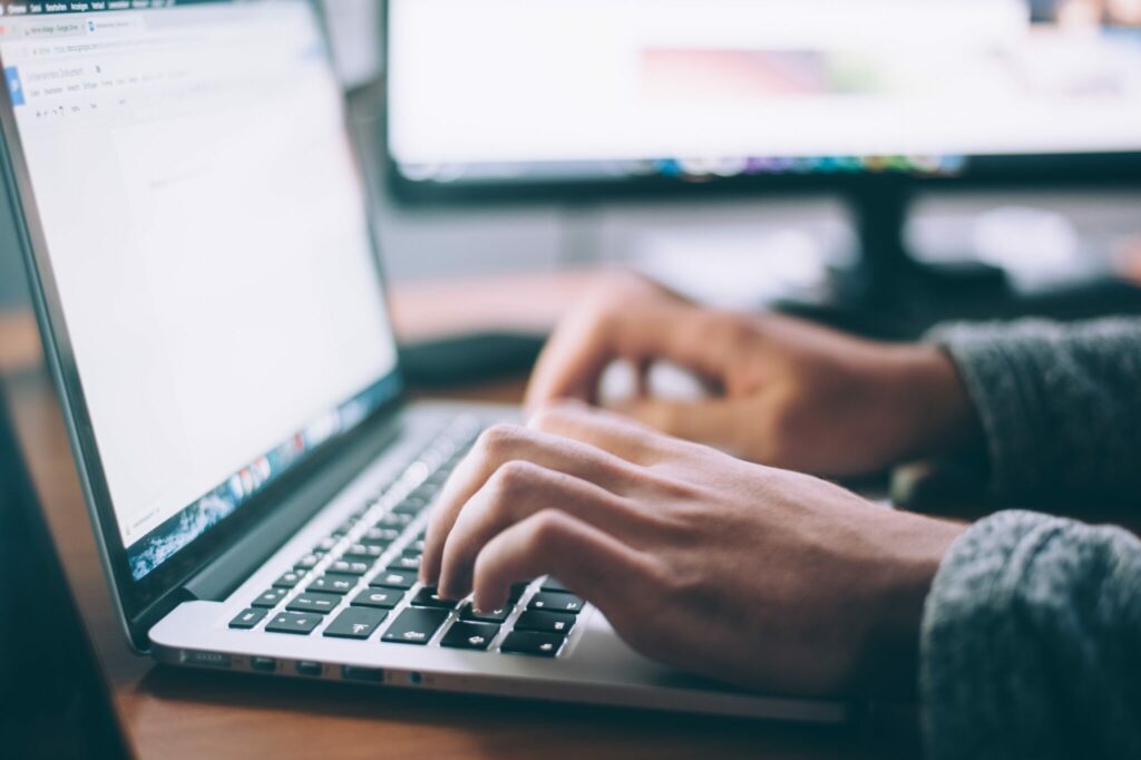 Person typing on the keyboard of a laptop computer