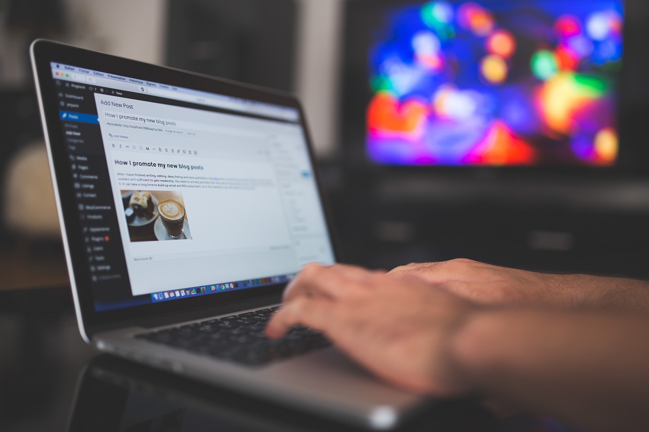 An image of someone writing a blog post on a mac book within WordPress.